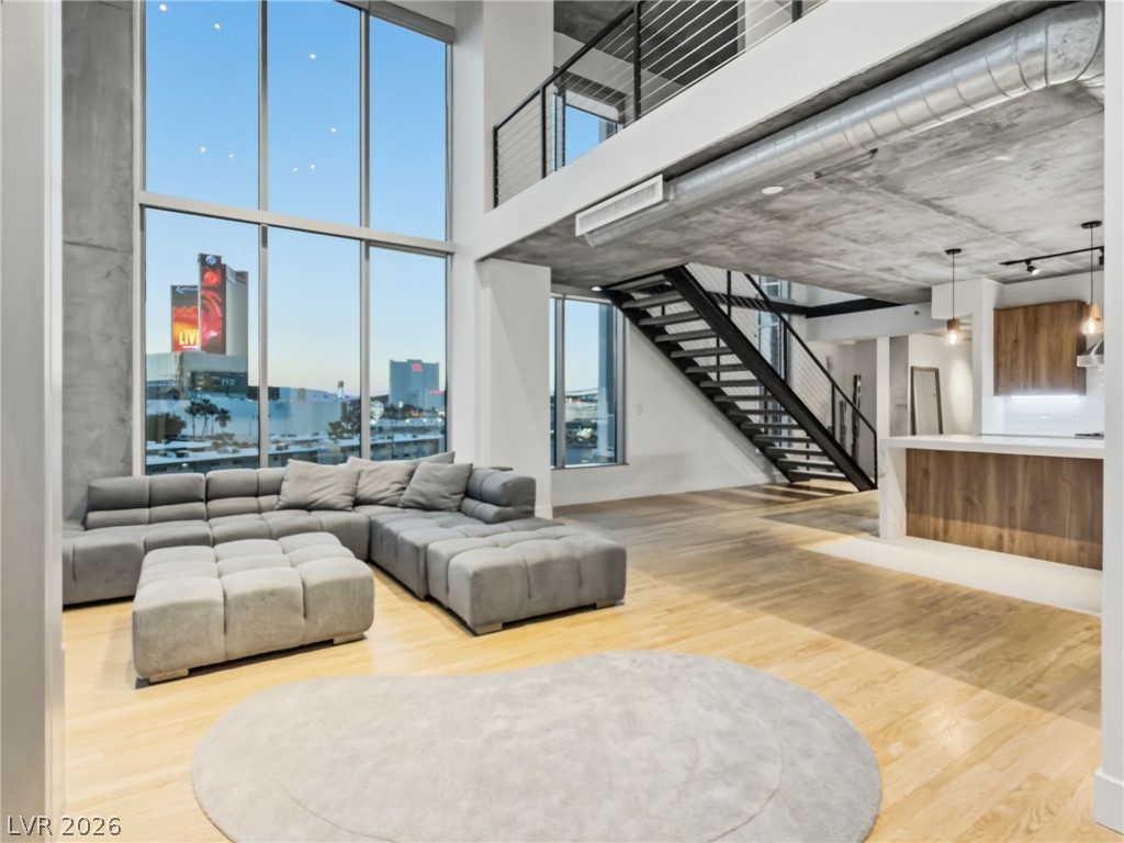 360 East Desert Inn Road, Unit 607 Las Vegas, NV 89109 - Photo 10 of 55 A spacious, open-concept loft with natural wood flooring and ample natural light from floor-to-ceiling windows.