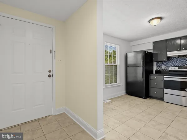 a kitchen with a refrigerator and a sink
