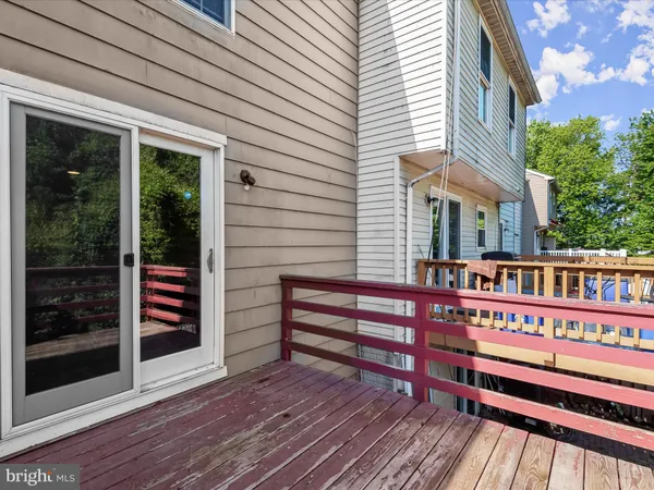 a view of a roof deck with wooden floor and fence