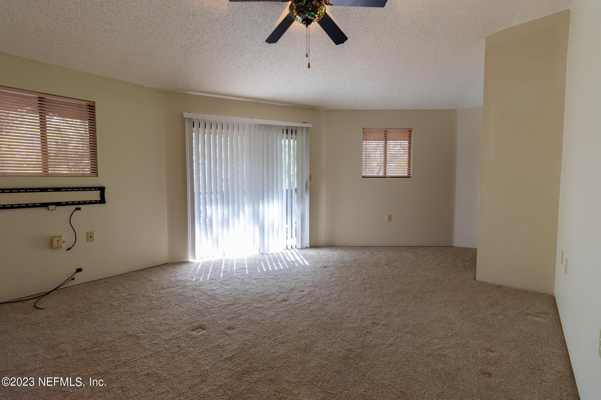 1151 Southeast 46th Loop Keystone Heights, FL 32656 - Photo 12 of 39 a view of an empty room with chandelier fan and window