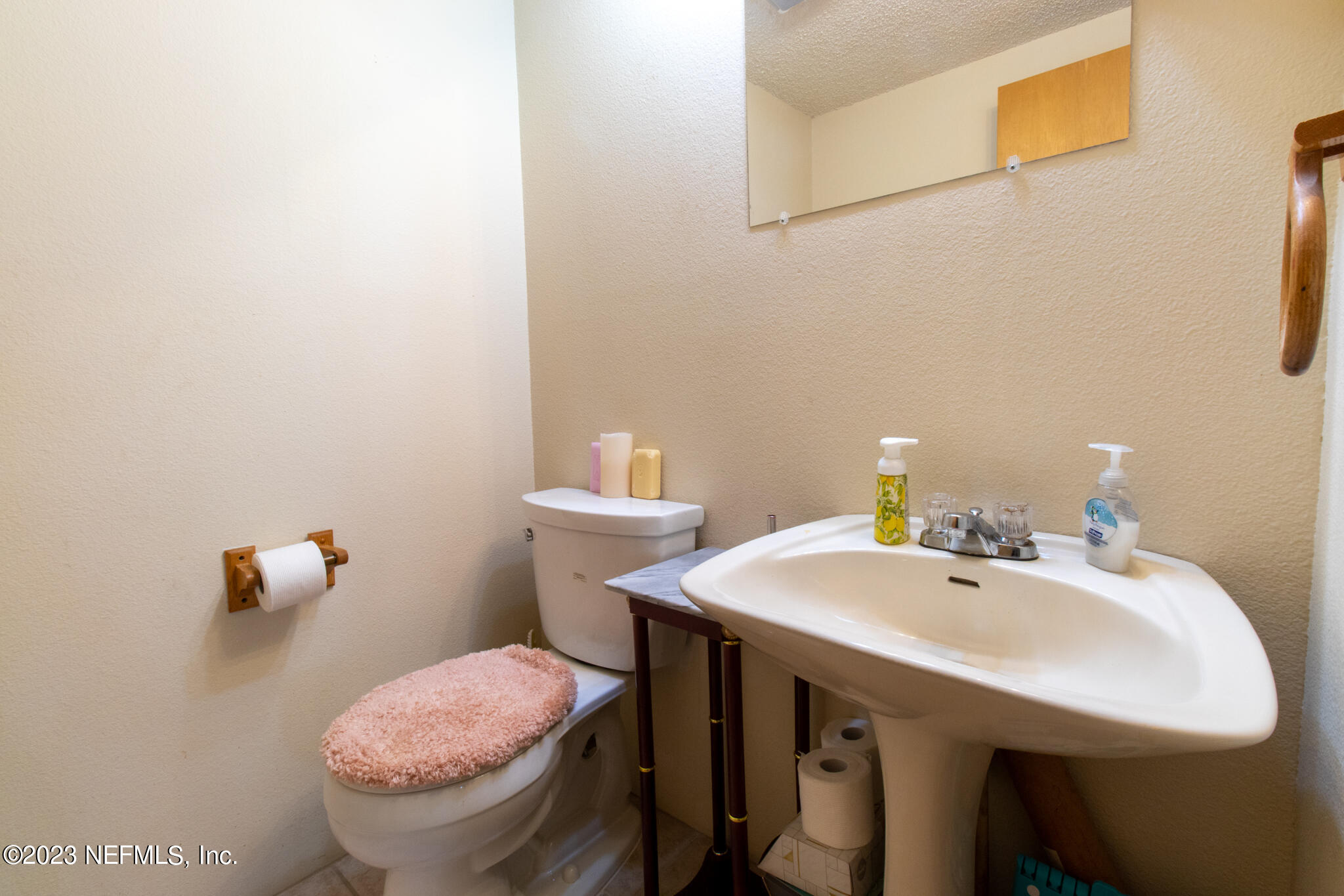 1151 Southeast 46th Loop Keystone Heights, FL 32656 - Photo 28 of 39 a bathroom with a sink a toilet and a mirror