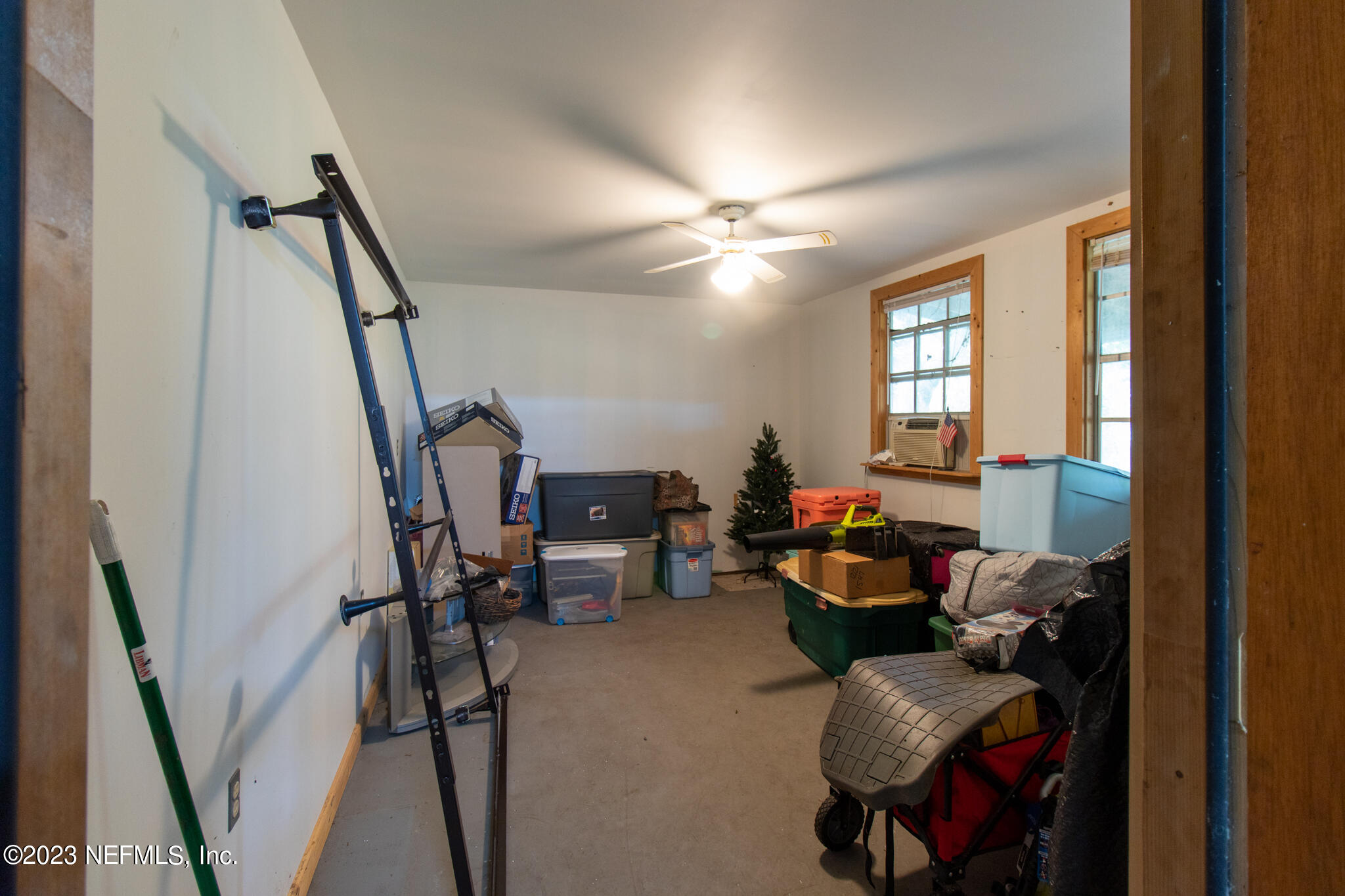 1151 Southeast 46th Loop Keystone Heights, FL 32656 - Photo 35 of 39 a living room with furniture and a chandelier