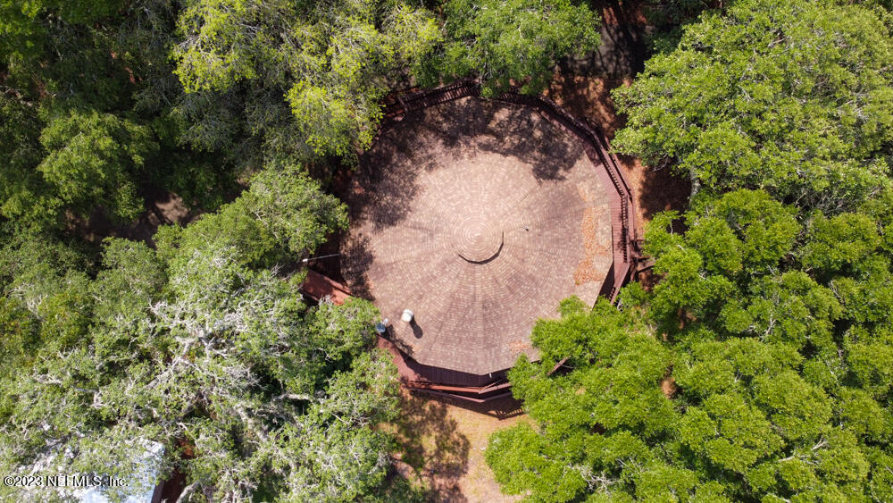 1151 Southeast 46th Loop Keystone Heights, FL 32656 - Photo 36 of 39 an aerial view of a house with a yard and trees all around
