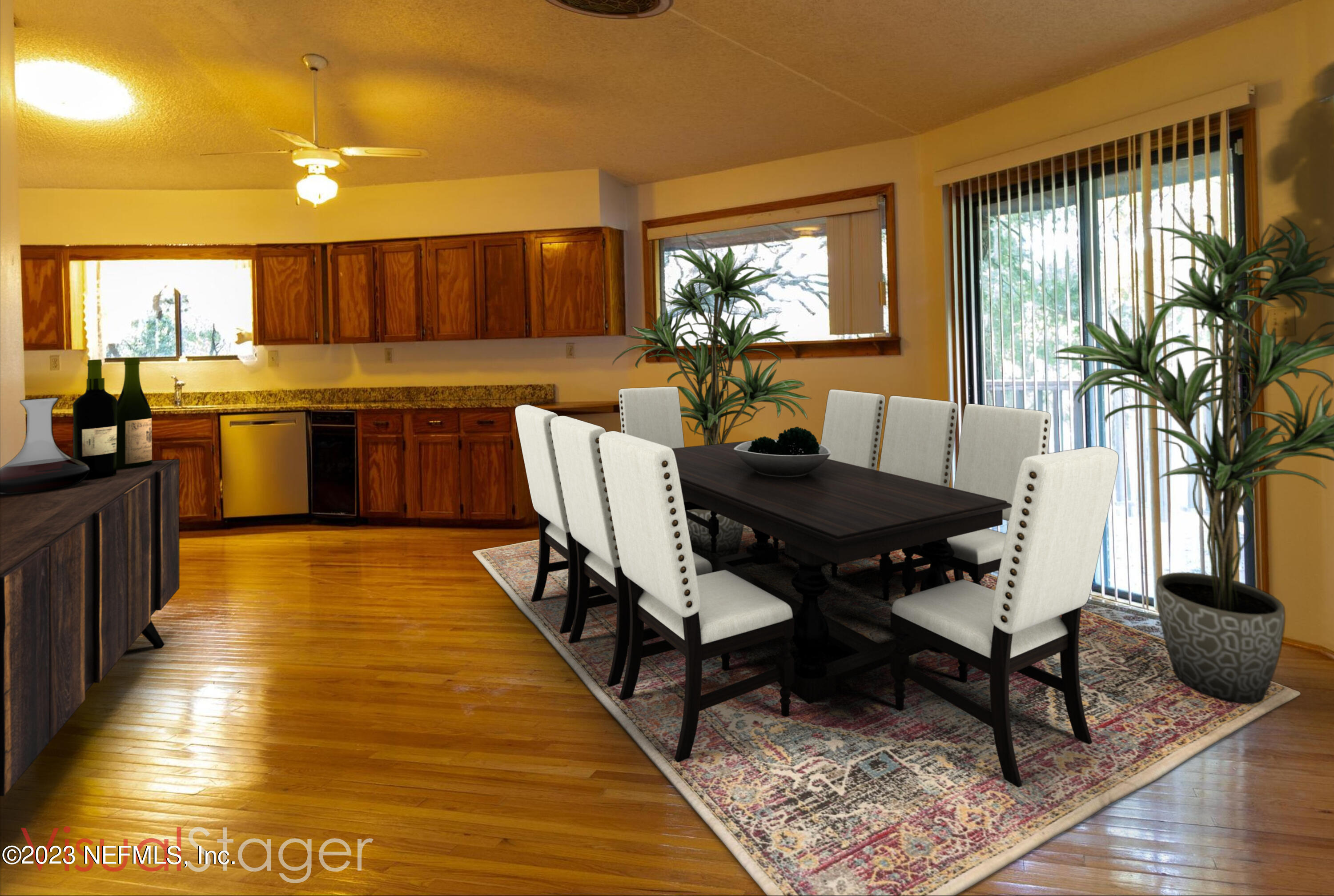 1151 Southeast 46th Loop Keystone Heights, FL 32656 - Photo 8 of 39 a living room with a couch dining table wooden floor and a large window