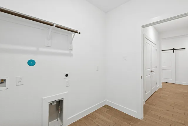 a view of a big room with a big yard and large tree