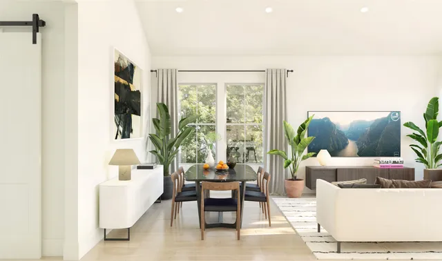 a living room with furniture and a potted plant