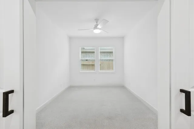 an empty room with windows and closet
