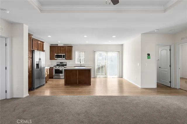 a view of kitchen with stainless steel appliances refrigerator oven microwave and cabinets