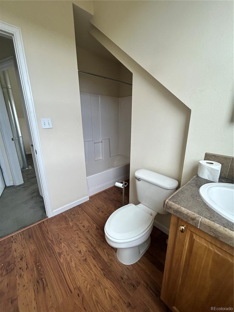 52601 County Rd LL56 Villa Grove, CO 81155 - Photo 12 of 33 a bathroom with a granite countertop toilet and a sink