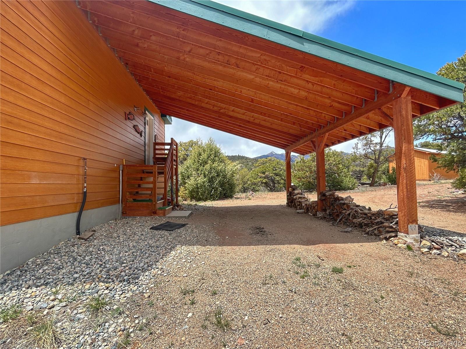 52601 County Rd LL56 Villa Grove, CO 81155 - Photo 3 of 33 a backyard of a house with a large tree