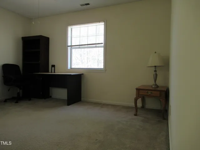 a room that has a window and a chair