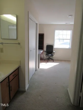 a view of livingroom with workspace and a window