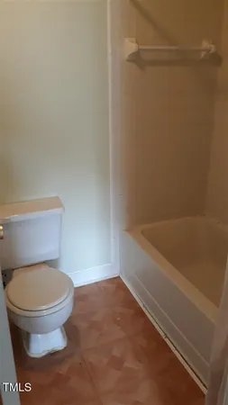 a bathroom with a toilet and a bath tub