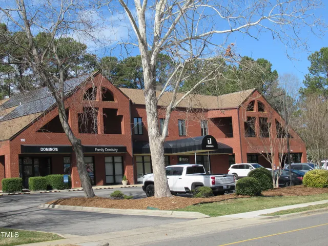 a car parked in front of white house