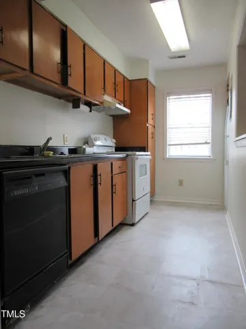 a kitchen with stainless steel appliances granite countertop a stove a sink and dishwasher