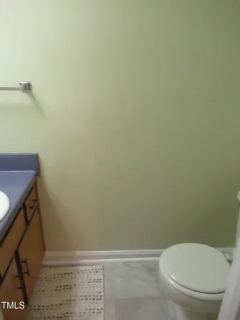 a white toilet sitting next to a shower