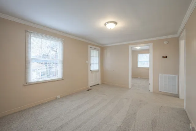 an empty room with windows and closet