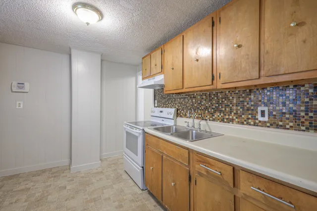 a kitchen with a sink and cabinets