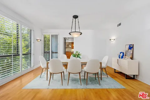 a view of a dining room with furniture window and wooden floor