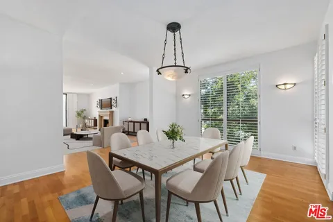 a view of a dining room with furniture wooden floor and chandelier