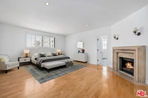 a spacious bedroom with a bed and a fireplace