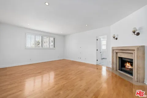 a view of empty room with a fireplace