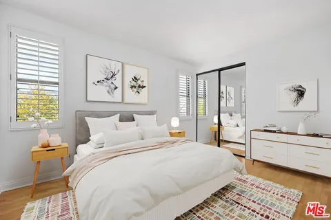 a bedroom with double bed and a window