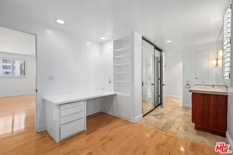 a view of a kitchen with a refrigerator and a sink