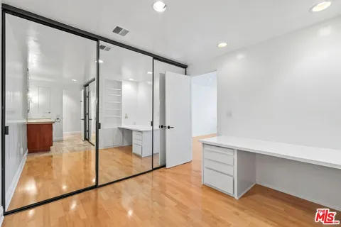 a spacious bathroom with a glass shower door and a mirror