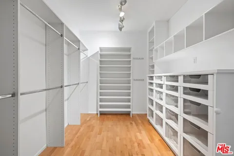 a view of walk in closet with empty racks