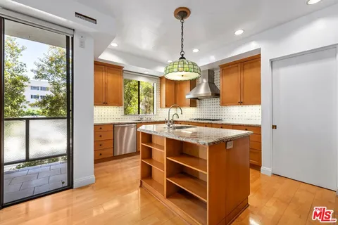 a kitchen with stainless steel appliances granite countertop a stove and a sink