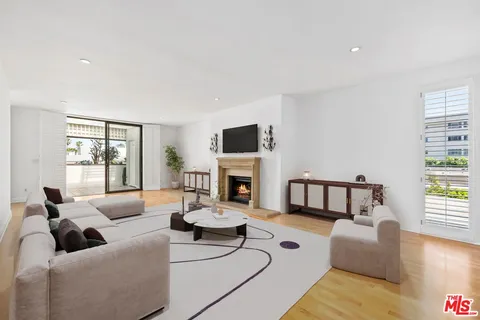 a living room with fireplace furniture and a wooden floor