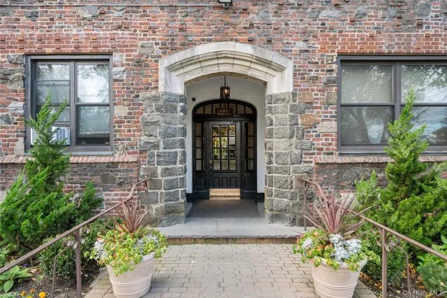 a living room with furniture a fireplace and a potted plant
