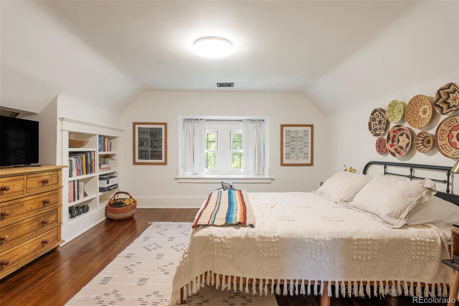 720 Franklin Street Denver, CO 80218 - Photo 22 of 39 a bedroom with a bed and a flat screen tv