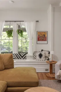 a living room with furniture and large windows