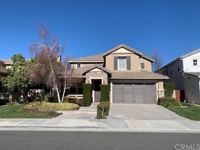 46172 Pinon Pine Way Temecula, CA 92592 - Photo 1 of 1 a front view of a house with a garden