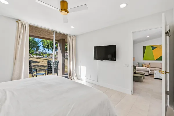 a bedroom with a bed and a flat screen tv