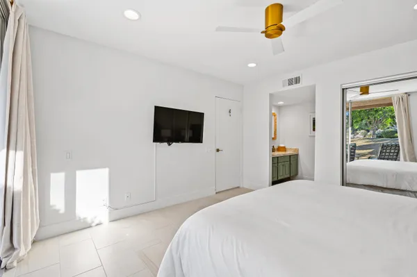 a bedroom with a bed and a flat screen tv