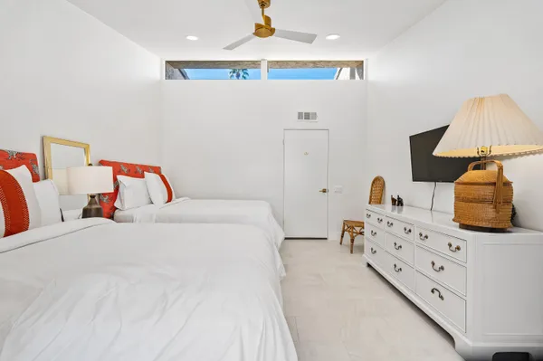a bedroom with a bed and a dresser