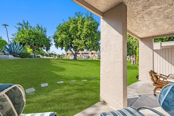 a view of yard from deck patio