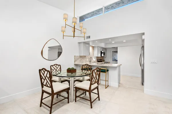 a dining room with furniture and a mirror