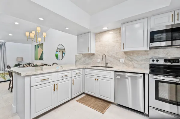 a kitchen with a sink stove and microwave