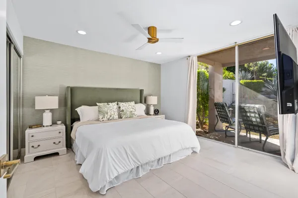 a bedroom with a large bed and a large window
