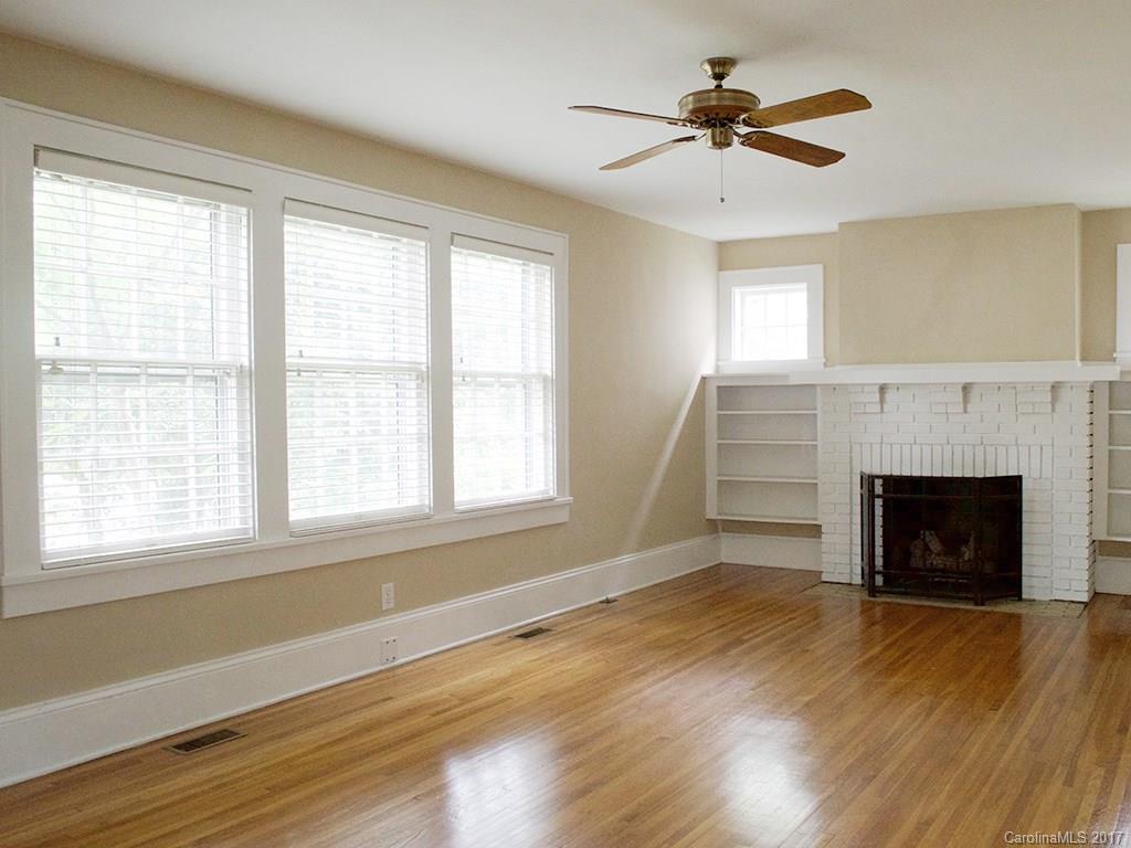 2304 Sharon Road Charlotte, NC 28207 - Photo 3 of 8 a view of an empty room with a window and fireplace