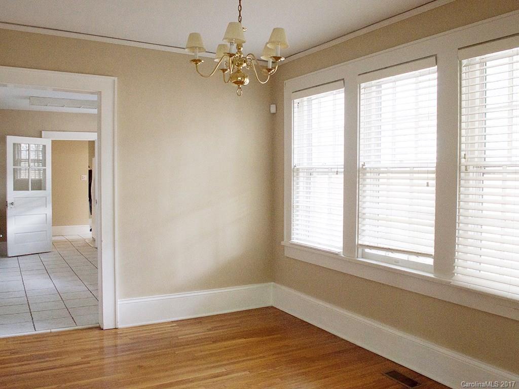 2304 Sharon Road Charlotte, NC 28207 - Photo 4 of 8 a view of an empty room with wooden floor and a window