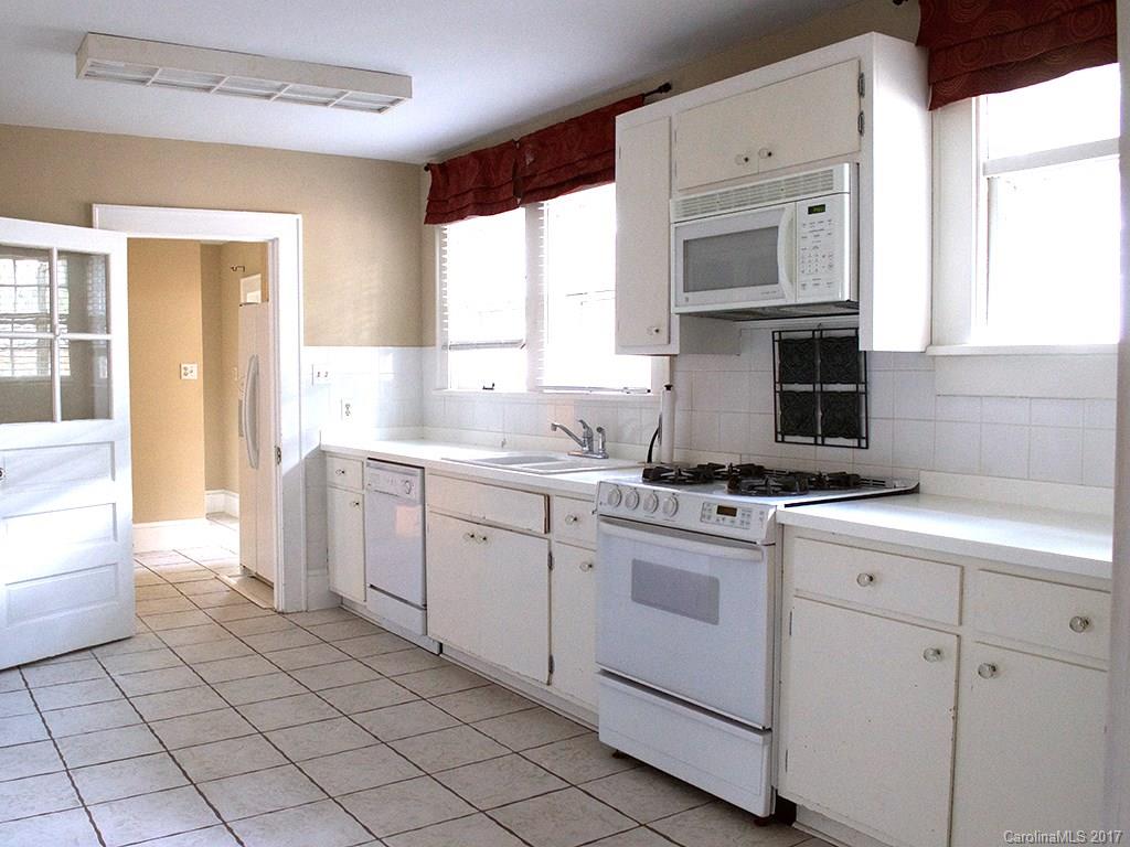 2304 Sharon Road Charlotte, NC 28207 - Photo 5 of 8 a kitchen with a sink cabinets and window