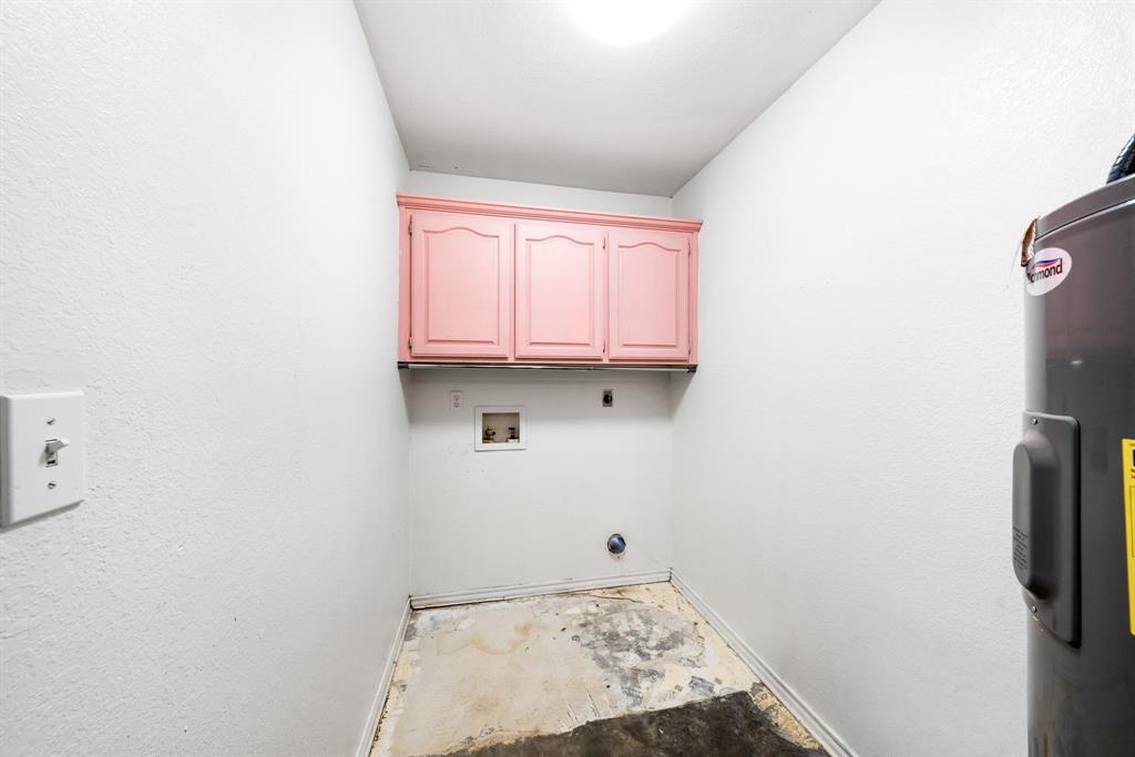 903 Amy Way Bonham, TX 75418 - Photo 17 of 27 Laundry room with cabinet space, electric dryer hookup, water heater, washer hookup, and a textured wall