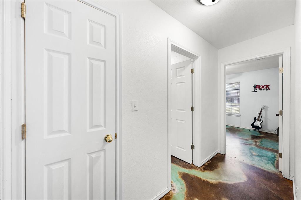 903 Amy Way Bonham, TX 75418 - Photo 21 of 27 Hallway with concrete flooring and baseboards