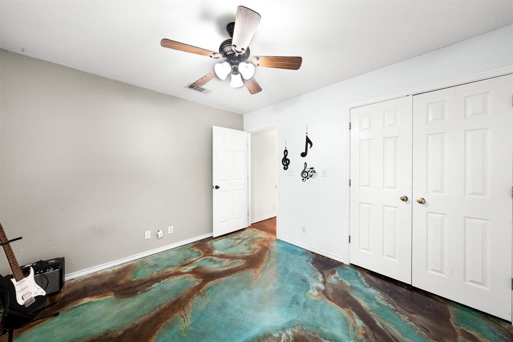 903 Amy Way Bonham, TX 75418 - Photo 25 of 27 Unfurnished bedroom with ceiling fan, concrete floors, and a closet