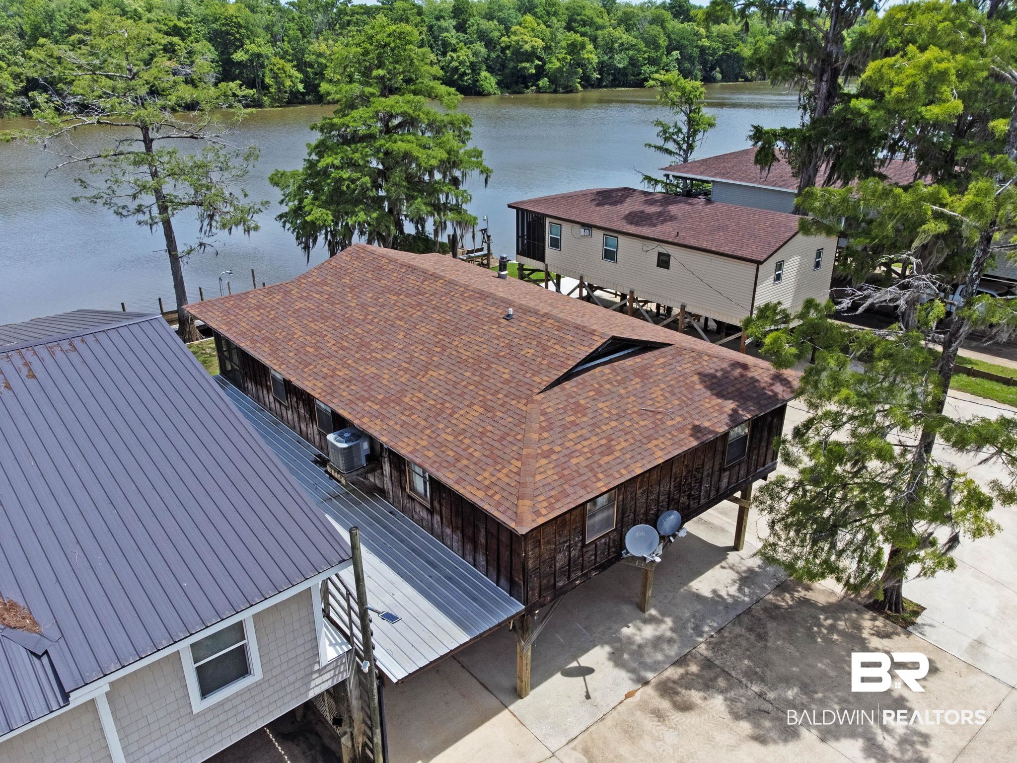 8153 Bryant's Lndg Road Stockton, AL 36579 - Photo 9 of 87 Waterfront property with brown shingle roofing and wood-panel siding, elevated on pilings